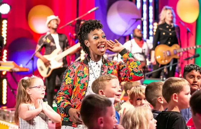 A singer and band with young children joining in